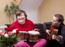 Two Woman playing an instrument