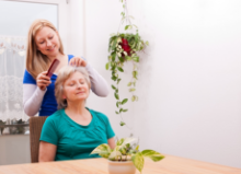 Caregiver fixed the hair of the Old woman